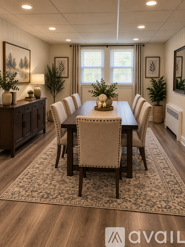 A dining room with a wooden table and chairs.