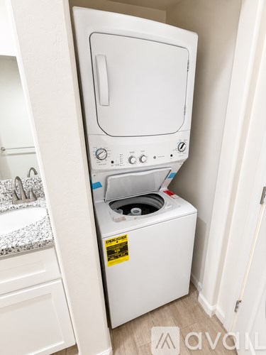 A white washing machine in a small room.