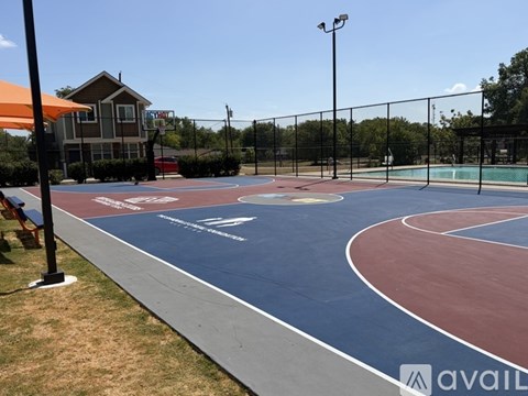 A basketball court with a blue and red surface and white lines.