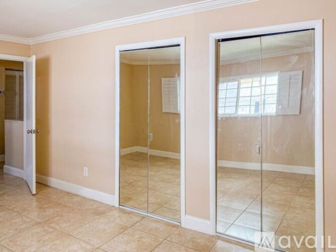 A room with a sliding glass door leading to a balcony.