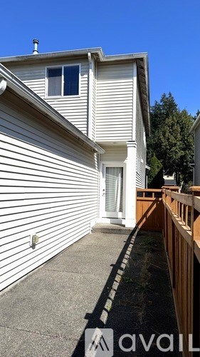 A house with a white exterior and a small porch.