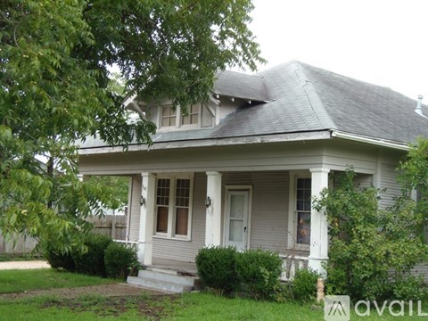 A house with a porch and a front yard.