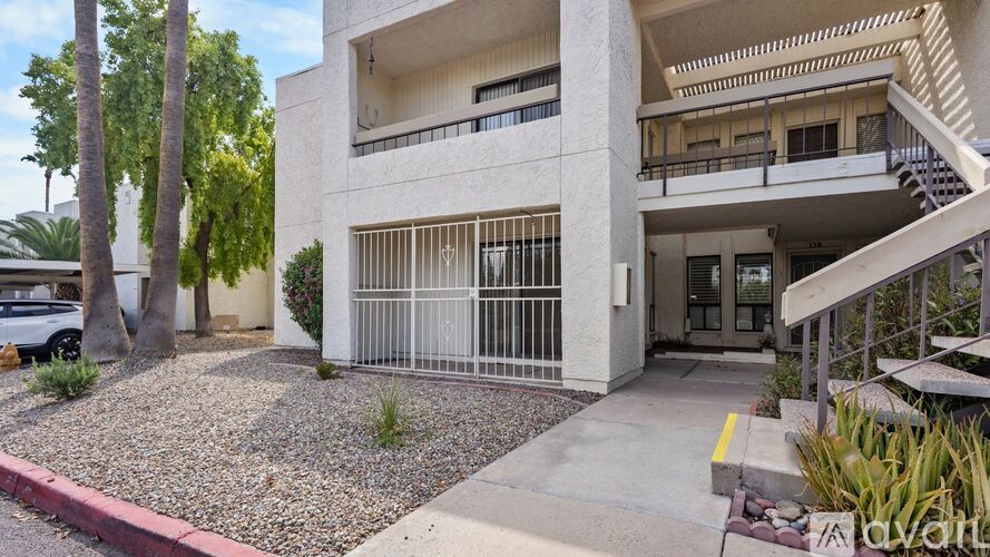A modern building with a white fence in front.