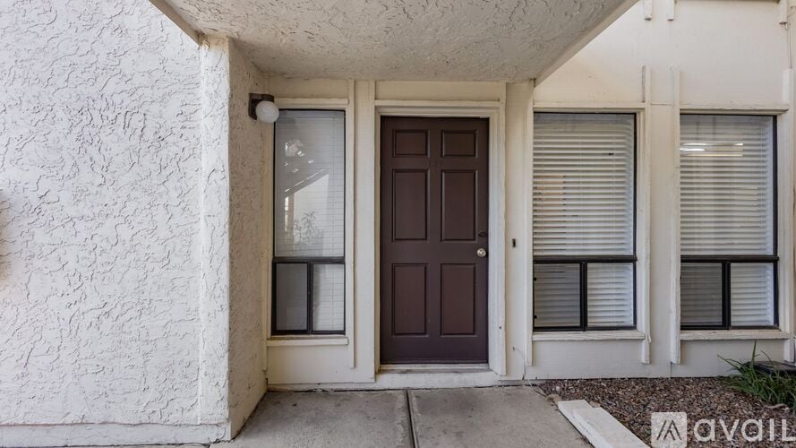 A house with a brown door and white walls.
