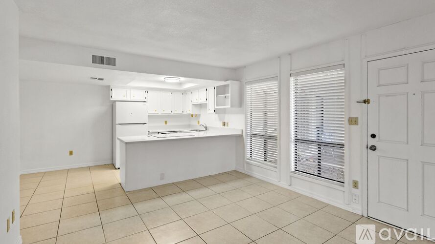 A kitchen with white cabinets and a countertop.
