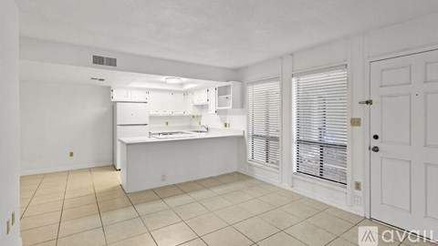A kitchen with white cabinets and a countertop.
