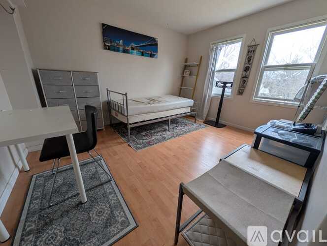 A bedroom with a bed, desk, and chair.