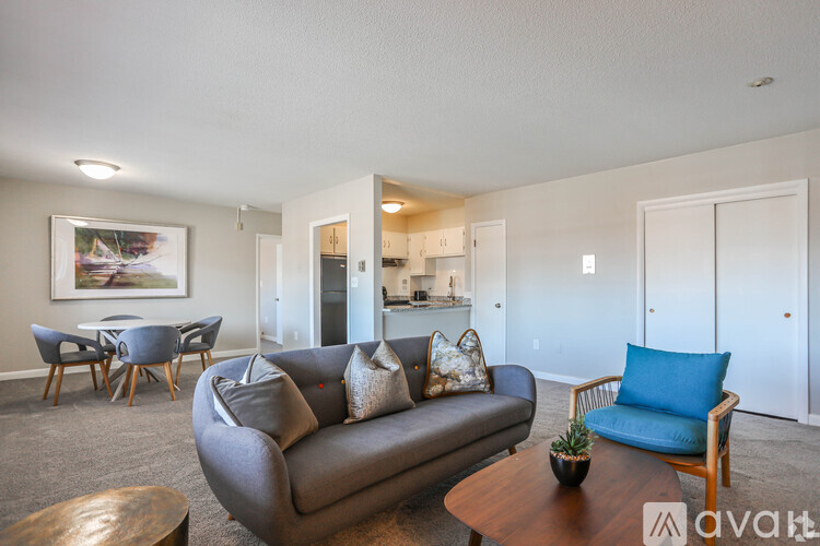A living room with a grey couch and a wooden coffee table.