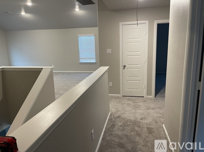A room with a white door and a window with blinds.