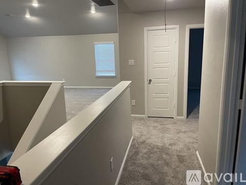 A room with a white door and a window with blinds.