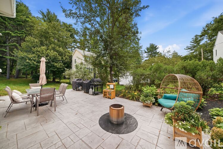 A backyard with a fire pit and seating area.