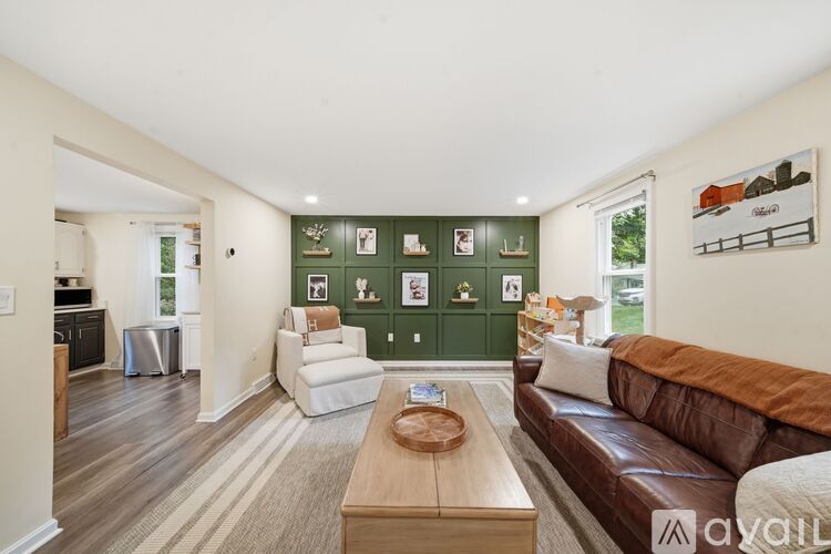 A living room with a brown couch and a coffee table in the center.