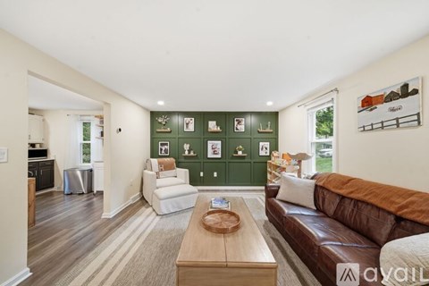 A living room with a brown couch and a coffee table in the center.