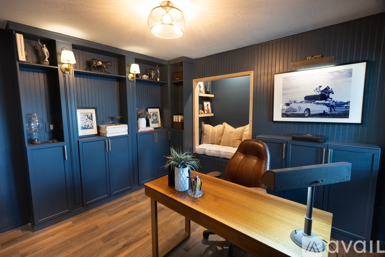 A room with a wooden table and a brown chair.