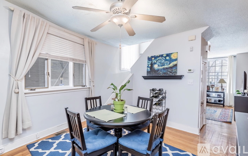 A dining room with a table set for four.
