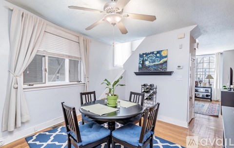 A dining room with a table set for four.