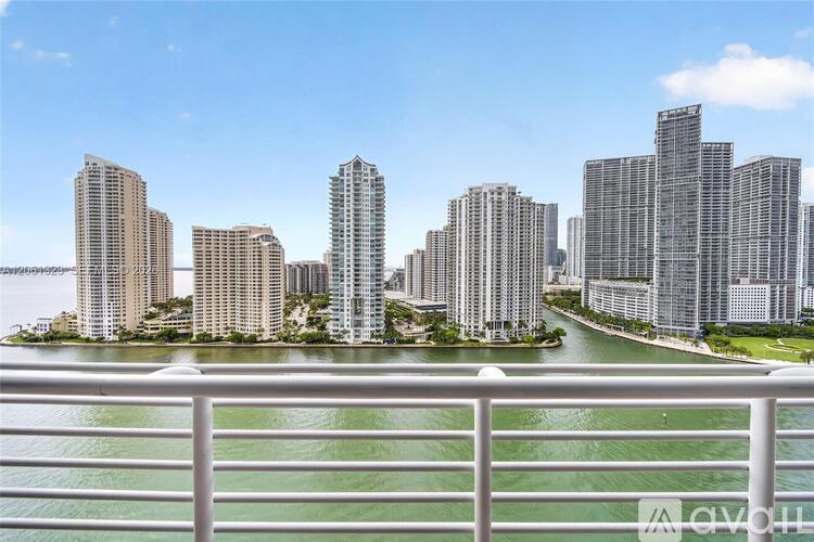 A row of high-rise buildings are seen from a balcony.