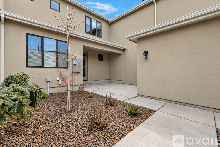 A beige house with a brown gravel area in front.