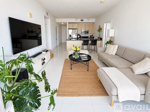 A living room with a grey couch and a coffee table.