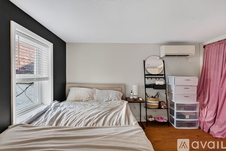 A bedroom with a large bed and a window overlooking a body of water.