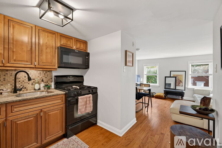 A kitchen with wooden cabinets and a black stove top oven.