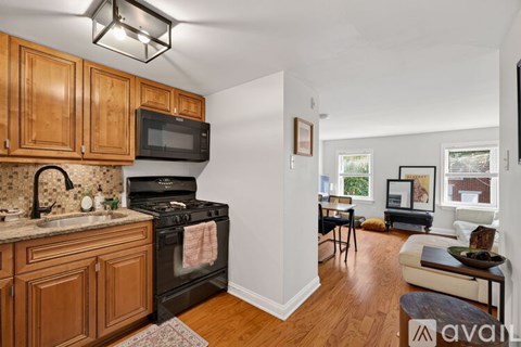 A kitchen with wooden cabinets and a black stove top oven.