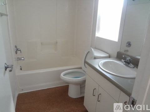 A bathroom with a toilet, sink, and bathtub.