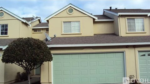 A house with a tree in front of it.