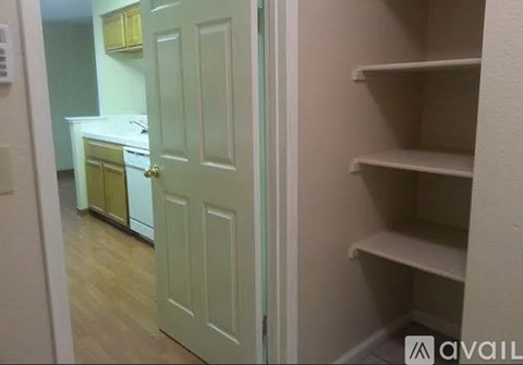 A kitchen with a white door and a yellow cabinet.
