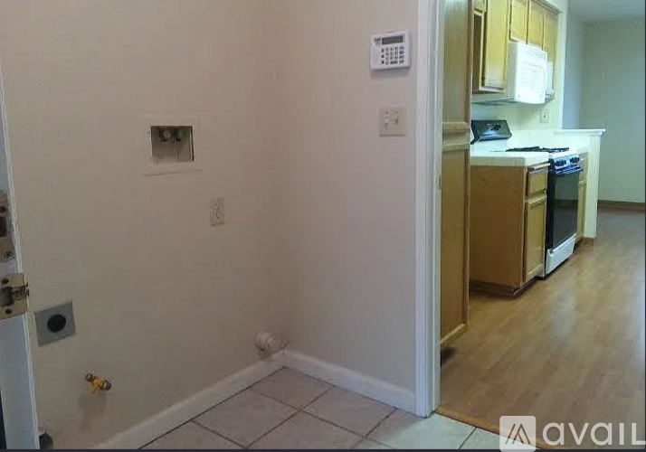 A kitchen area with a refrigerator, oven, and microwave.