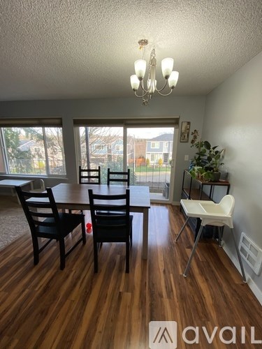 A dining room with a table and chairs.