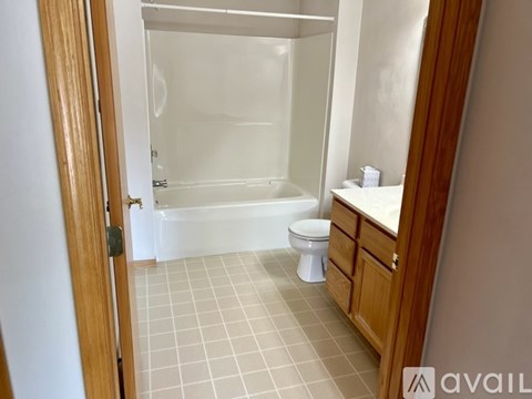 A bathroom with a toilet, sink, and bathtub.