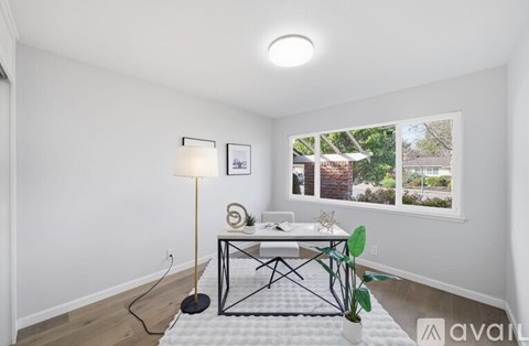 A room with a table and a lamp.