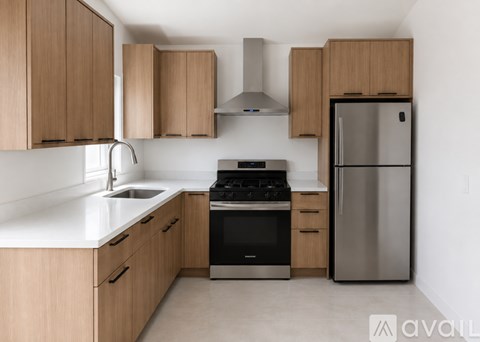A kitchen with wooden cabinets and stainless steel appliances.