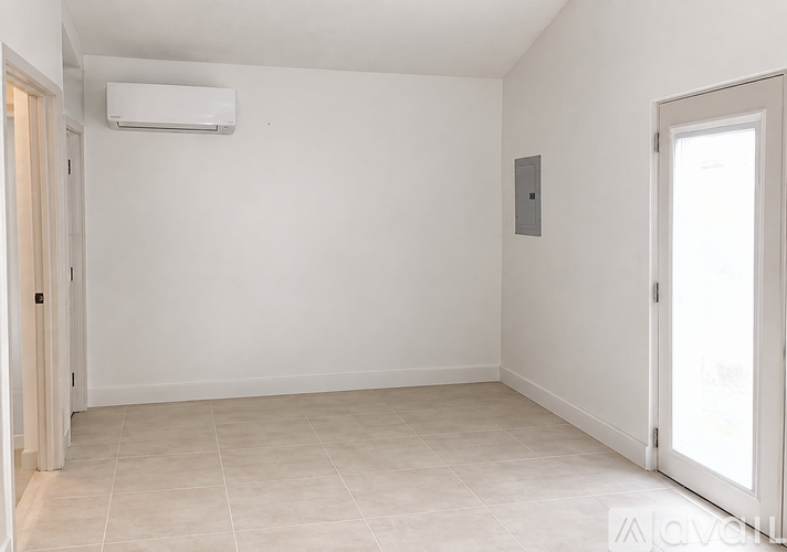 A room with a tiled floor and a sliding door.