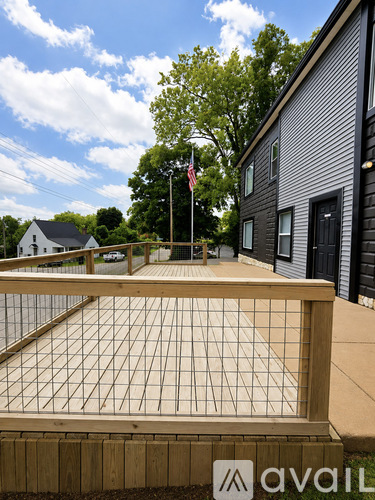 A wooden fence with a metal grate in the middle.