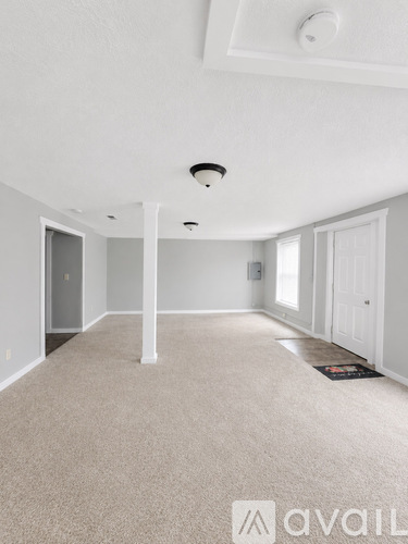 A room with carpeted floor and white walls.