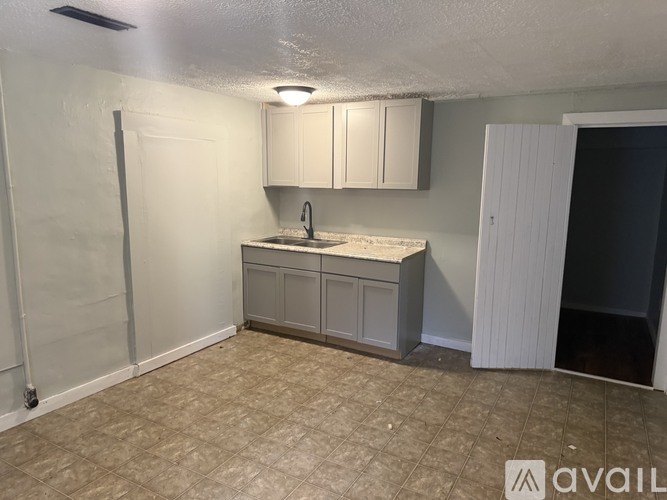A kitchen area with a sink and cabinets.