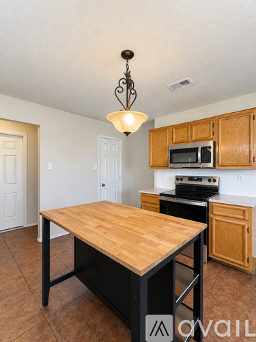 A kitchen with a wooden table and chairs.