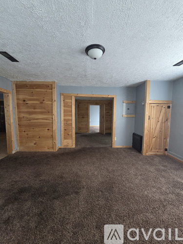 A room with wooden walls and carpeted floor.