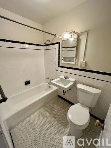 A white toilet sits next to a sink in a small bathroom.