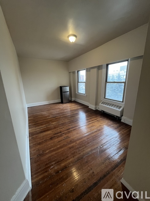 A room with wooden floors and white walls.