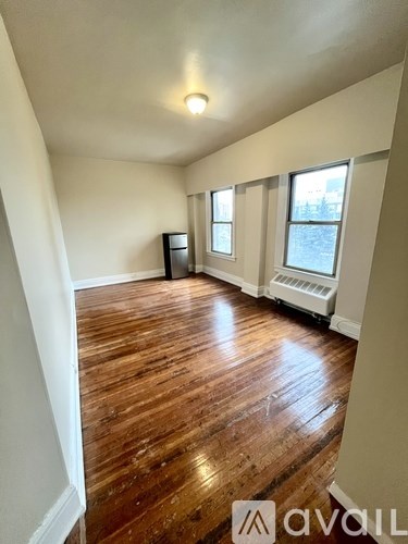 A room with wooden floors and white walls.