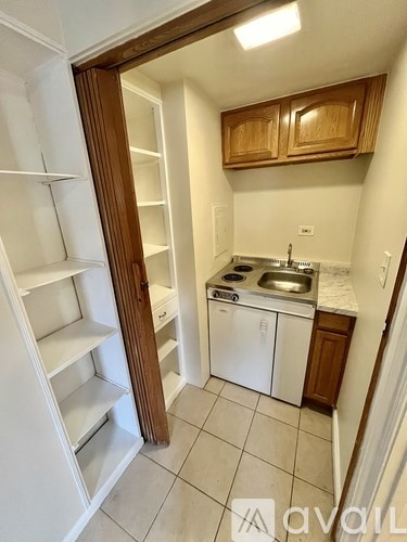 A small kitchen with white appliances and wooden cabinets.