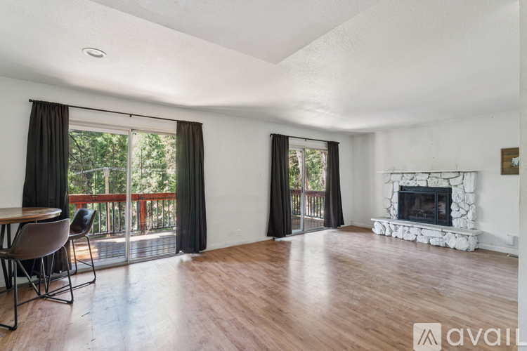 A living room with a fireplace and sliding glass doors.