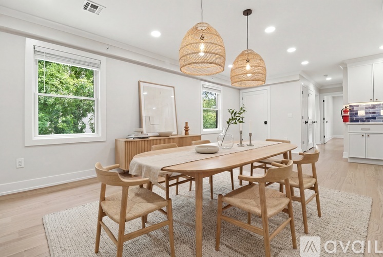 A dining room with a wooden table and chairs.
