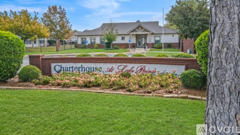 A sign that says Charterhouse of St. Louis is in front of a building.