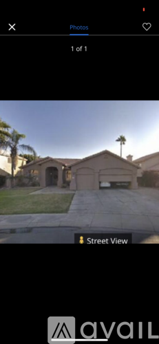 A house with a brown roof and a white garage door.