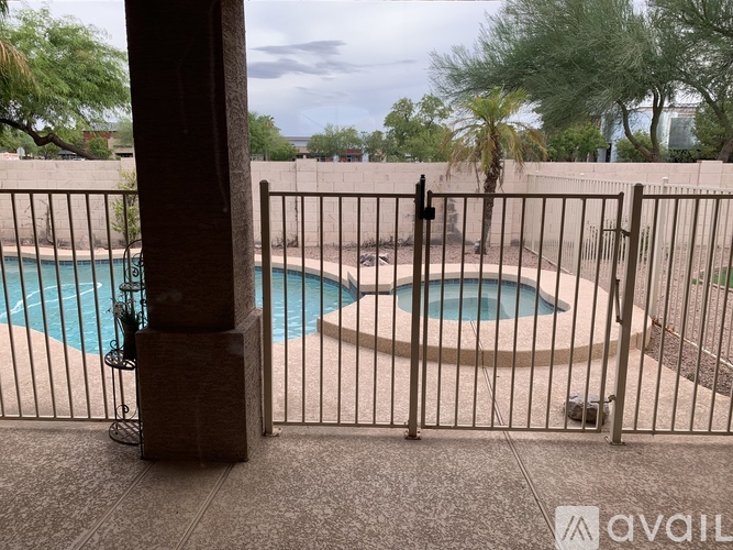 A pool surrounded by a fence.