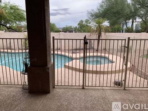 A pool surrounded by a fence.